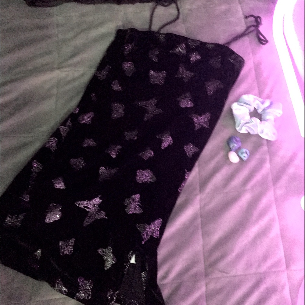 Black mini dress with silver sparkly butterflies and mini split on thigh